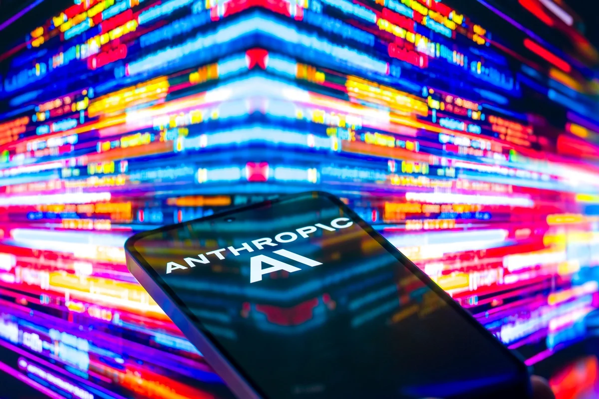 The Anthropic AI logo is displayed on a mobile phone with a visual digital background in this photo illustration in Brussels, Belgium, on December 7, 2025. (Photo by Jonathan Raa/NurPhoto via Getty Images)