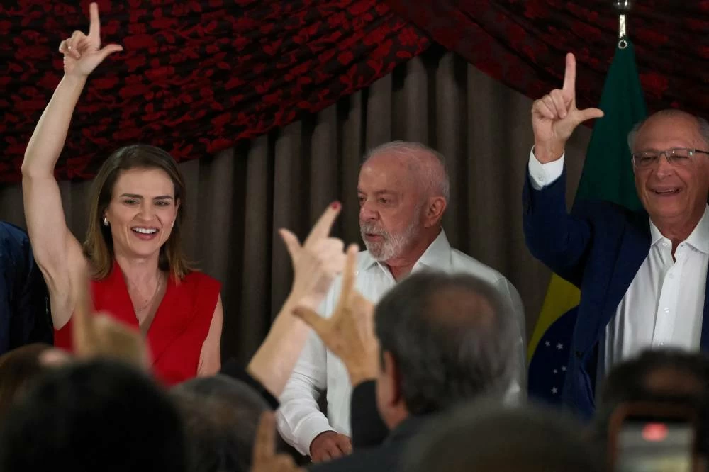 Brazilian President and Workers' Party (PT) candidate for presidential re-election, Luiz Inacio Lula da Silva, stands with former Federal Deputy of Brazil Marilia Arraes and Brazilian Vice President Geraldo Alckmin, as they gesture, during a meeting with political allies ahead of the presidential election runoff, in Brasilia, Brazil, October 5, 2026. (Reuters)