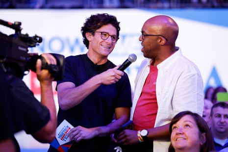 a man holds a microphone to a person standing next to him